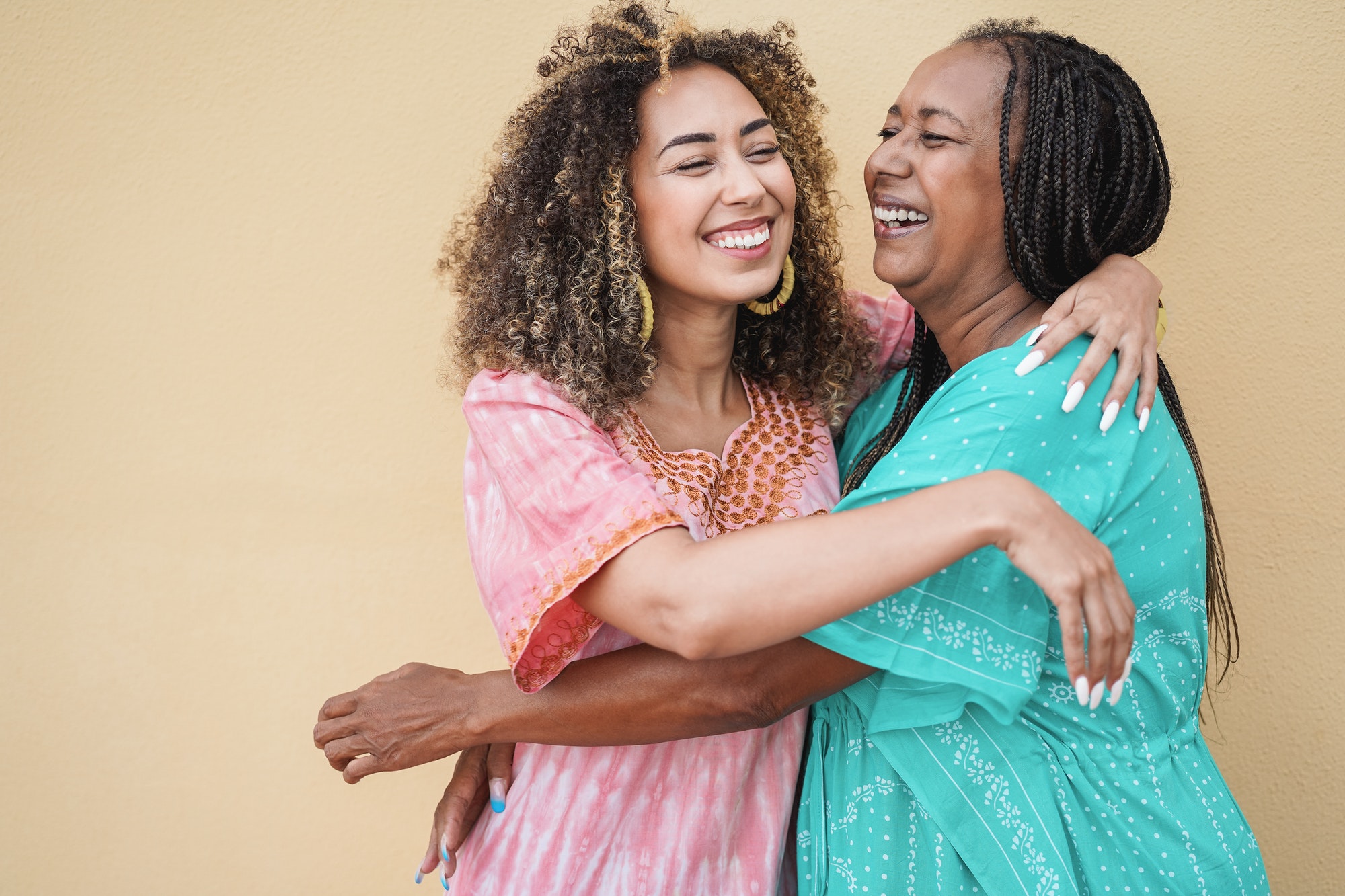 Happy african mother and daughter hugging each others - Love and family concept